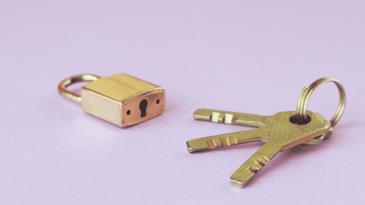 Purple Background with Gold Lock and Three Keys on a Keychain Lock and Keys for Accessibility